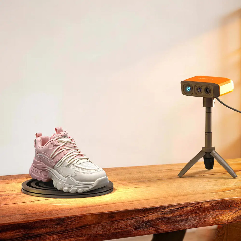 Pink and white chunky sneaker with thick soles displayed on a rotating stand scanned by 3DMakerpro Fox 3D scanner