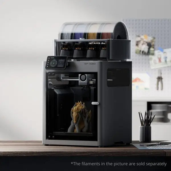 Bambu lab x2d black and silver x80 3d printer with transparent filament storage displaying multiple colored spools
