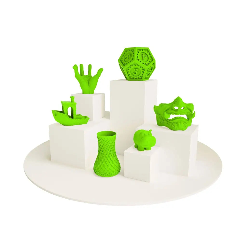 Green 3D-printed novelty items displayed on white pedestals with PLA Neon Filament