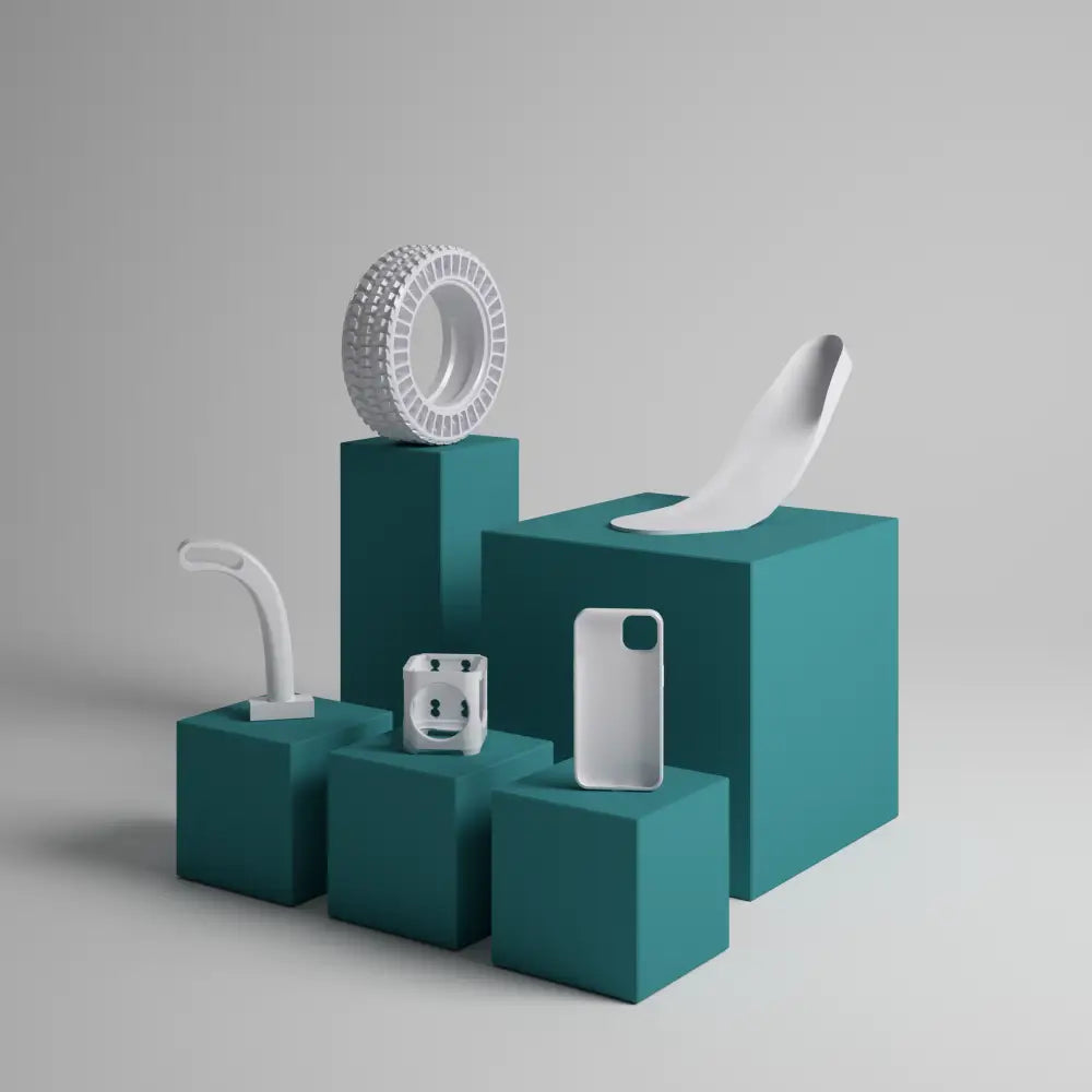 Collection of everyday objects arranged on teal-colored geometric blocks.