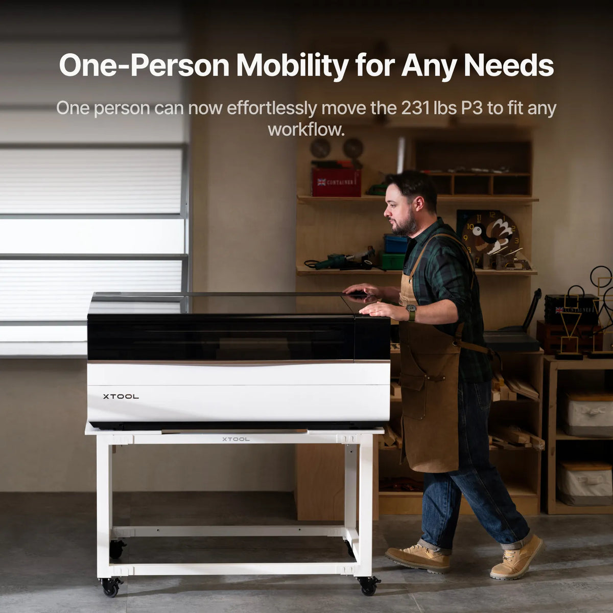 One person moving the xTool P3 on the mobile work stand