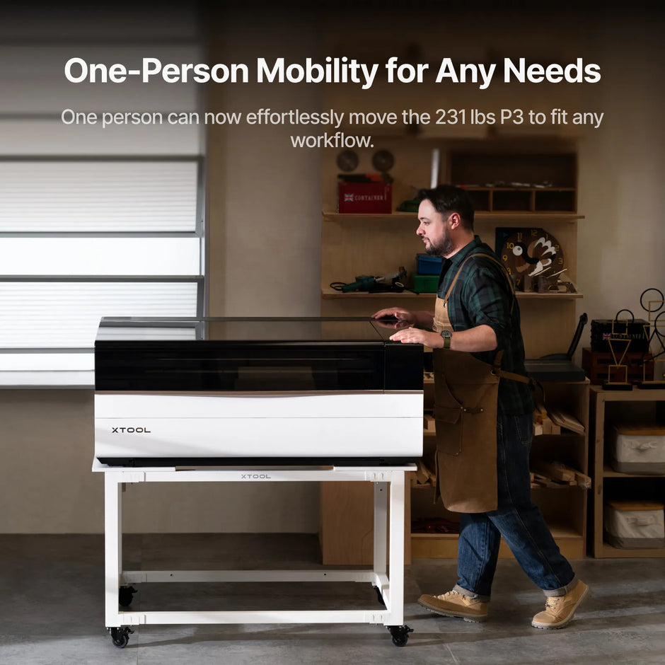 One person moving the xTool P3 on the mobile work stand